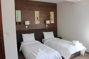 Postel nebo postele na pokoji v ubytování Trigrad Hotel