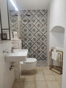 a bathroom with a toilet and a sink and a mirror at Schwandorf22 in Bretten