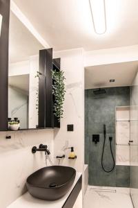 a bathroom with a black sink and a shower at VERDANT by Cozy Stories in Alexandroupoli