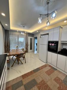 a kitchen with a table and a dining room at Sapanca Villa Dereiçi in Sapanca