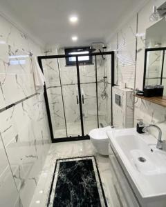 a white bathroom with a sink and a toilet at Sapanca Villa Dereiçi in Sapanca