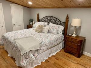 a bedroom with a bed and a night stand with a lamp at Driftwood House in Mead