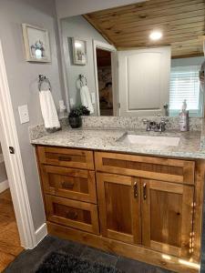 a bathroom with a sink and a mirror at Driftwood House in Mead +15 photos