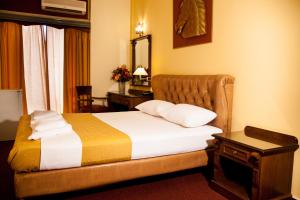 a hotel room with a bed and a mirror at Galini Palace in Athens