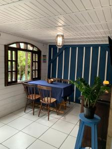 a dining room with a blue table and chairs at Bela Vista - Casa Beira Mar in Paranaguá