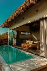 a resort with a swimming pool and a bed at Pousada Casa Buriti - Atins in Atins