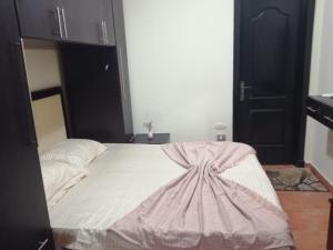 a bedroom with a bed with a dress on it at Porto marina special chalet sea view in El Alamein