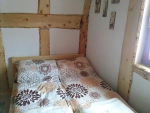 a small bedroom with a bed with a floral comforter at Apartments Gaga in Jahorina