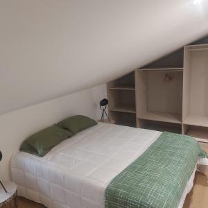 a bedroom with a large white bed with green pillows at Maria's House in Câmara de Lobos +45 photos