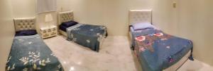 a room with two beds in a room at شالية السحاب in Al Ḩazm +76 photos