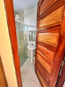 a bathroom with a toilet and a wooden door at Pousada do Gord0 in Bonito +32 photos