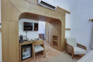 a room with a desk and a tv in a room at Silk Road Museum Hotel in Tokat