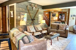 a living room with couches and chairs and a wall at Fireside Inn & Hostel in Breckenridge