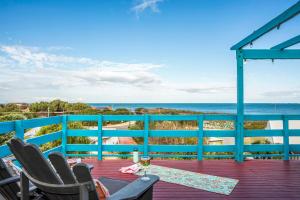a deck with chairs and a view of the ocean at Blue View - Ocean Views For Miles in Guilderton