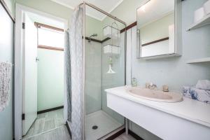 a white bathroom with a sink and a shower at Blue View - UNINTERRUPTED OCEAN VIEWS FOR MILES in Guilderton +18 photos