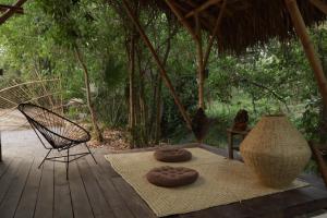 a deck with two donuts and a chair on it at Caravana junto al río en la huasteca potosina in Aquismón +24 photos