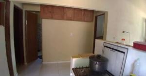 a kitchen with a stove top oven in a room at Casa na Serra in Bezerros