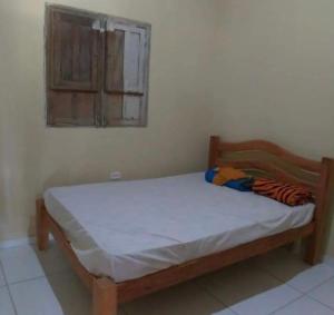 a small bed in a room with a window at Casa na Serra in Bezerros