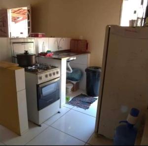 a kitchen with a stove and a refrigerator in it at Casa na Serra in Bezerros