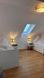 a room with two beds and two tables in it at Ferienhaus Boddenblick Klausdorf Am Nationalpark in Klausdorf Mecklenburg Vorpommern