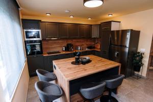a kitchen with a wooden counter and a refrigerator at Casa Lumi in Bugojno