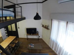 a living room with a bunk bed and a television at LoFt mANoLO in Montevideo