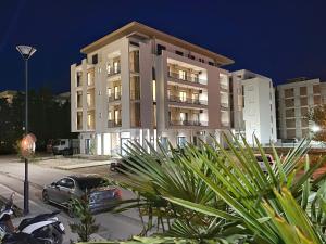 a building with a car parked in front of it at SUPREME Luxury in Ulcinj