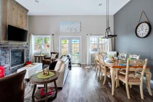 a living room with a couch and a table at Sandy Cove Cottage in Crystal Beach +31 photos