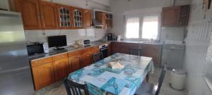 a kitchen with a table and a kitchen with wooden cabinets at Arasolis Fisterra in Fisterra