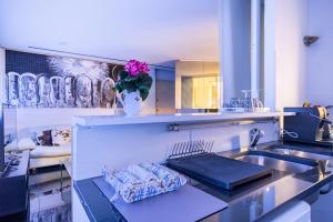 a kitchen with a sink and a vase of flowers at Luxury suite 2 min dal Politeama - Free Parking in Palermo
