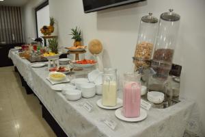 a long table with a buffet of food and drinks at Richmond Suites Hotel in Bogotá