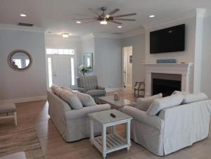 a living room with two couches and a fireplace at Horseshoe Manor in Little River