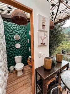 a bathroom with a toilet on a patio at Intrepido Glamping in Chinchiná +85 photos
