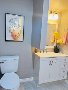 a bathroom with a toilet and a sink and a mirror at Retro Place - 2 bedroom & 1 bathroom - GREAT VALUE in Eagle Pass