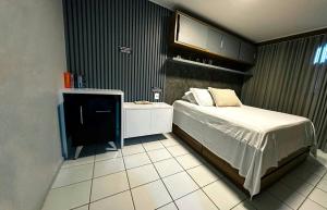 a bedroom with a bed and a tv in it at NEO BEIRA MAR PAJUCARA 2Qts 2WIFI 2 GARAG- Adm Nutelss in Maceió