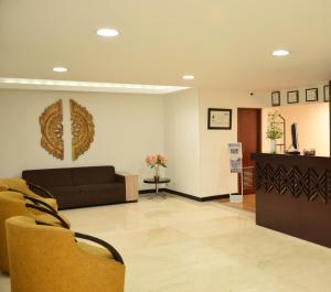 a waiting room with a couch and a table at Richmond Suites Hotel in Bogotá +20 photos