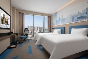 Telewizja i/lub zestaw kina domowego w obiekcie Hilton by Hampton Chengdu North Railway Station