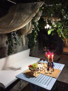a table with candles and flowers on top of it at Summer Stoned Maisonette in Kondiás +12 photos