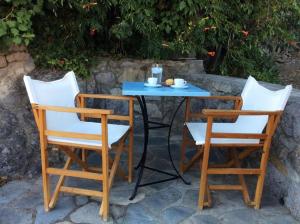 two chairs and a table with a blue table and chairs at Summer Stoned Maisonette in Kondiás