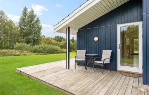 a deck with two chairs and a table on a house at Lovely Home In Knebel With Wifi in Knebel
