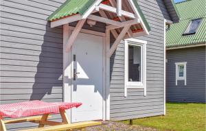 a shed with a white door and a green roof at 2 Bedroom Pet Friendly Home In Rewal in Rewal