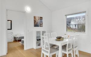 a white dining room with a white table and chairs at Nice Home In Vordingborg With Wifi in Vordingborg