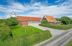 a house with an orange roof and a playground at Amazing Home In Grenaa With Sauna in Stokkebro +27 photos
