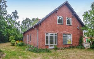 a red brick house in a yard at Three-Bedroom Holiday Home In Sakskobing in Sakskøbing