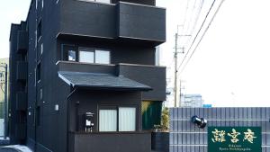 a black building with a sign on the side of it at Rikyuan Kyoto Nishikyogoku in Kyoto