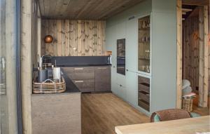 a kitchen with wooden walls and wooden floors and a counter at 4 Bedroom Stunning Home In Rauland in Rauland +11 photos