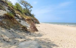 a sandy beach next to the ocean at Nice Home In Kladno With Wifi in Pleśna
