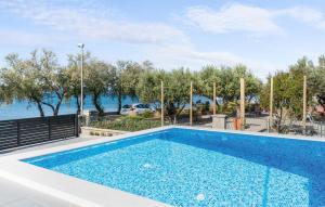 a swimming pool with a view of the water at 3 Bedroom Stunning Apartment In Vodice in Vodice