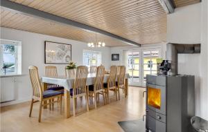 una cucina e una sala da pranzo con tavolo e sedie di 6 Bedroom Cozy Home In Dannemare a Dannemare