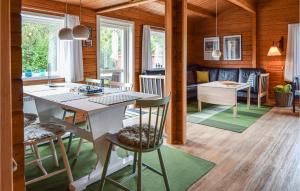 a kitchen and living room with a table and chairs at Alsbo in Sønderho